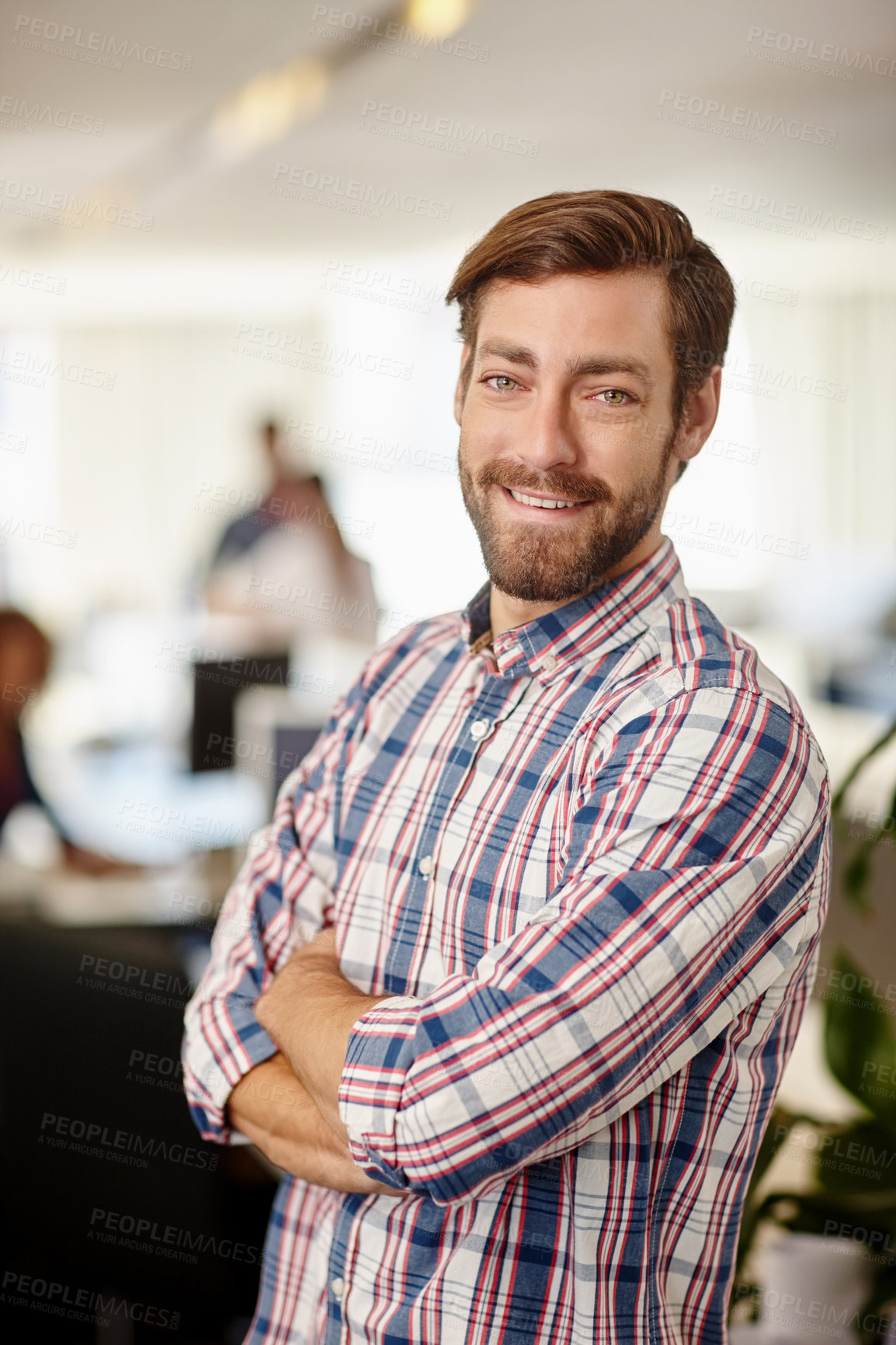 Buy stock photo Portrait of a confident young businessman standing in an office