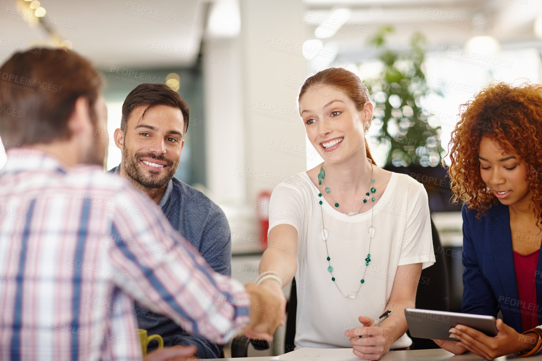 Buy stock photo Cropped shot of businesspeople shaking hands during a meeting in an office