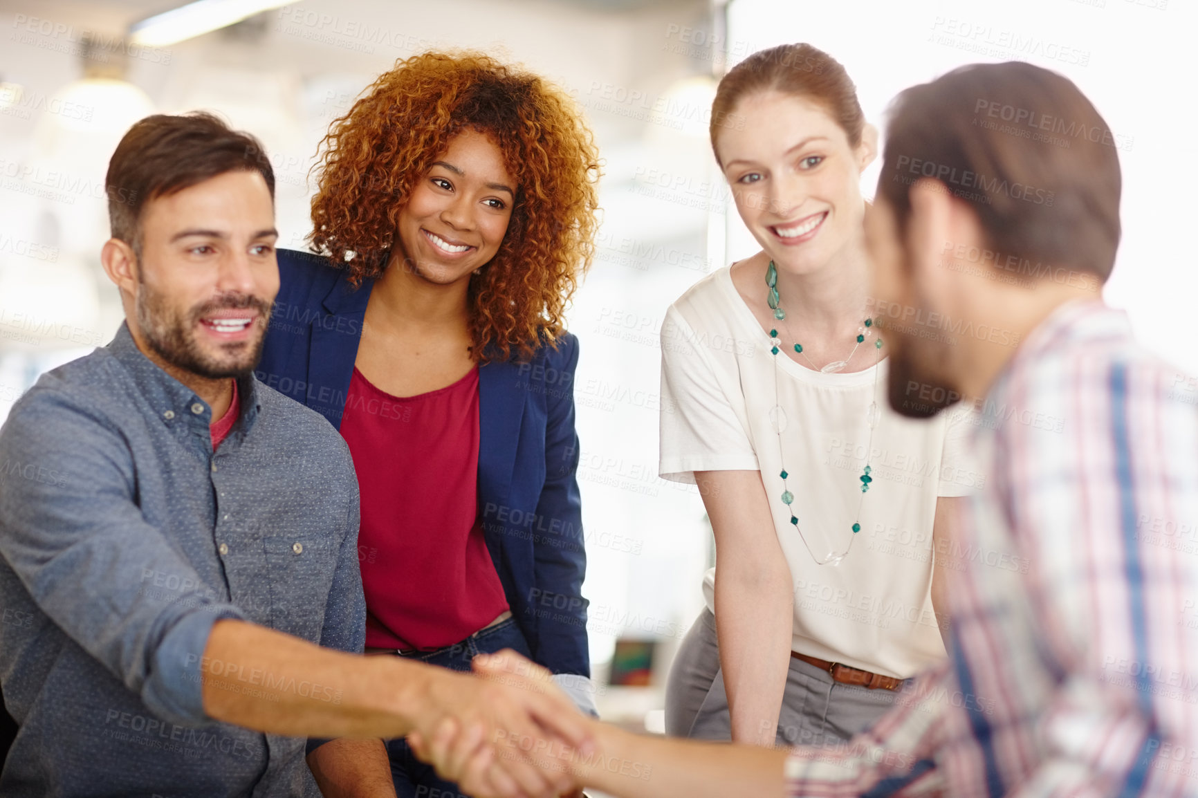 Buy stock photo Cropped shot of businesspeople shaking hands during a meeting in an office