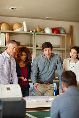 Buy stock photo Shot of a group of architects having a meeting in their office