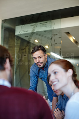 Buy stock photo Shot of a group of architects having a meeting in their boardroom