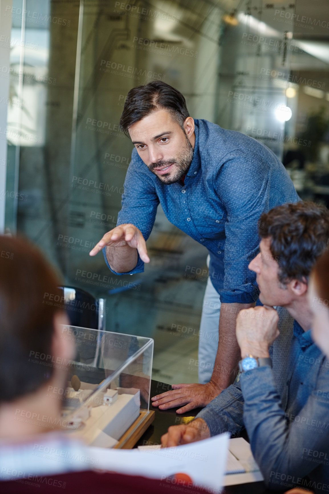 Buy stock photo Shot of a group of architects having a meeting in their boardroom