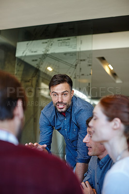 Buy stock photo Shot of a group of architects having a meeting in their boardroom