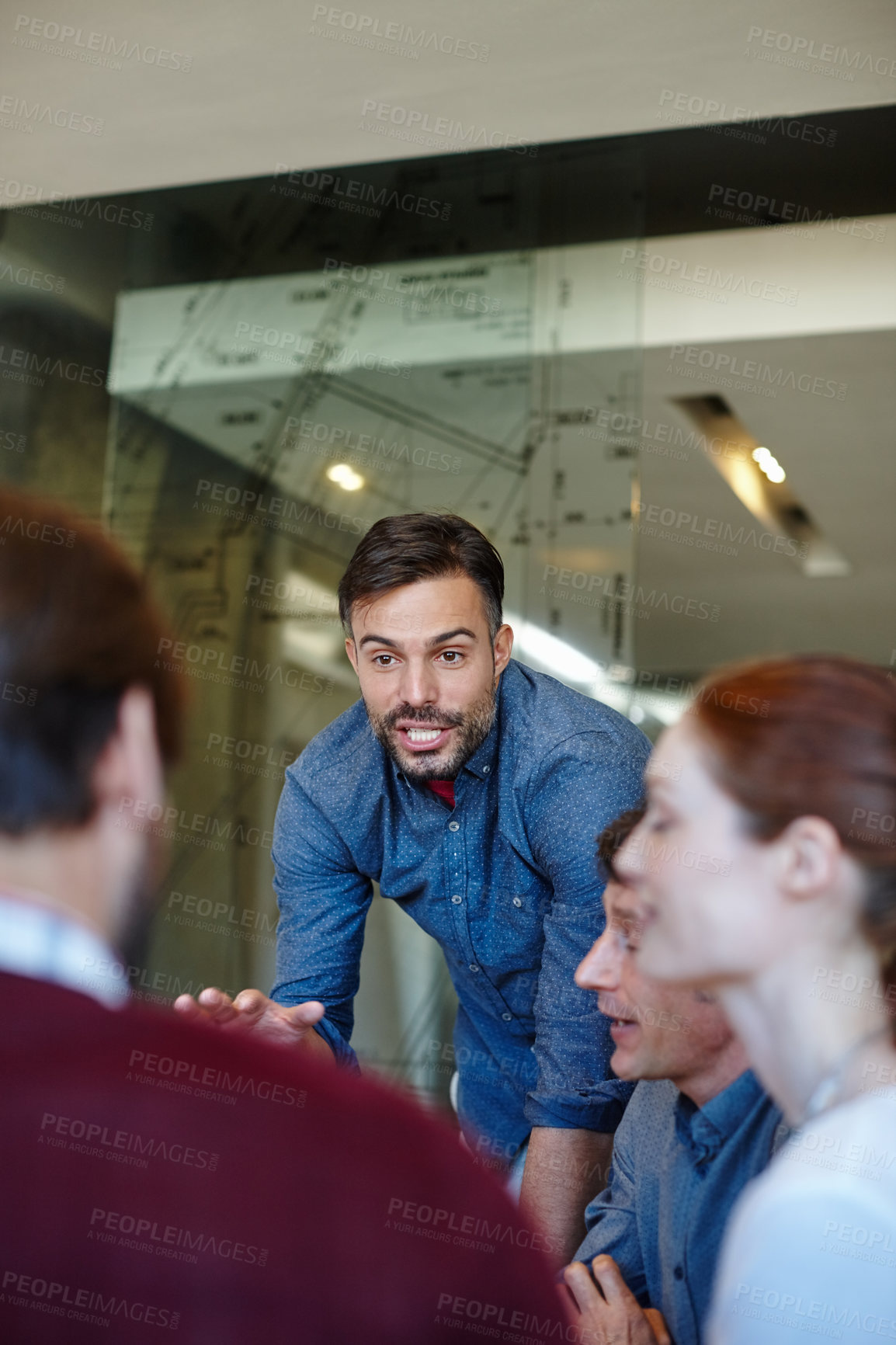 Buy stock photo Shot of a group of architects having a meeting in their boardroom