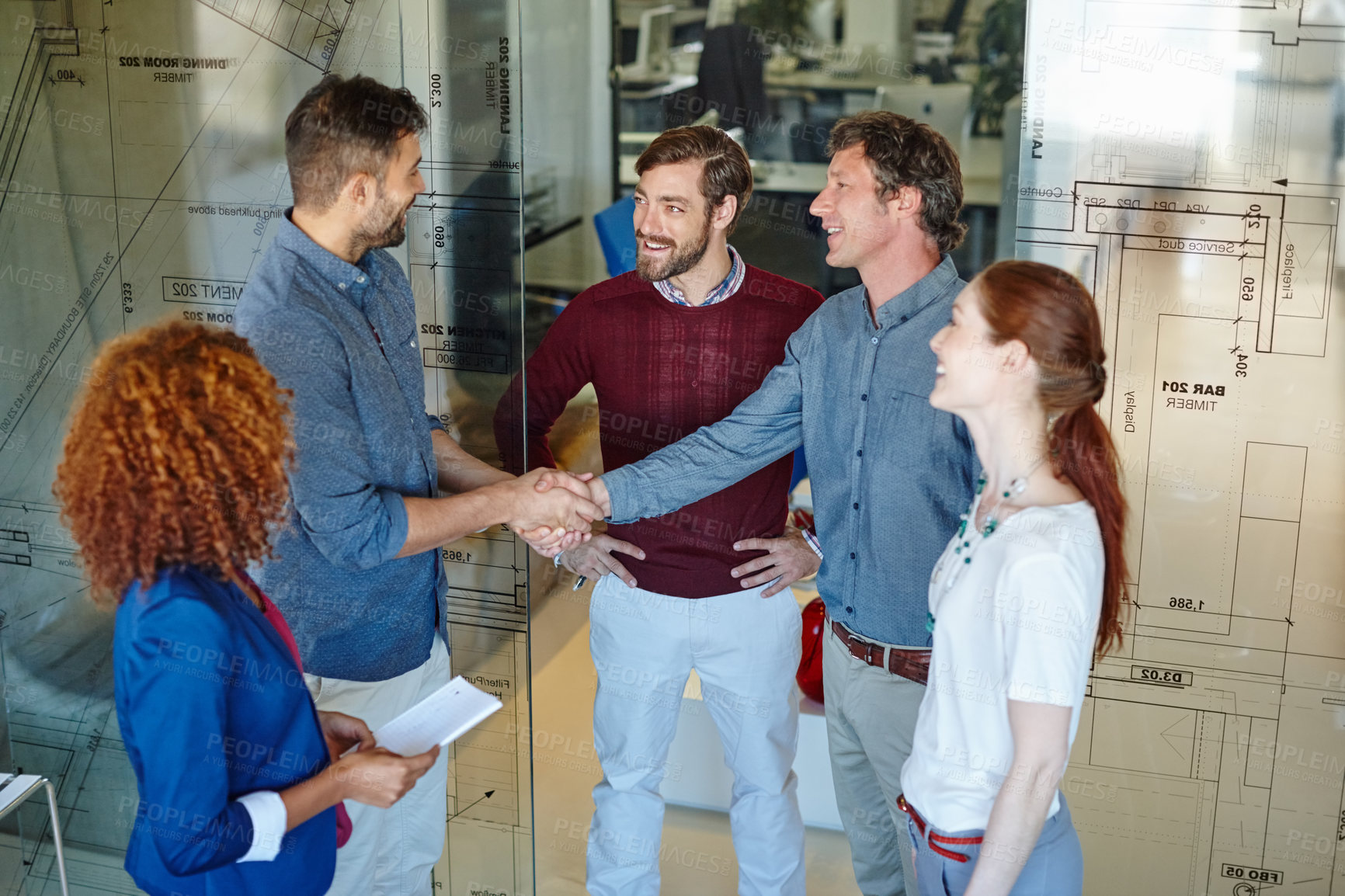 Buy stock photo Shot of a team of businesspeople introducing themselves to a new work colleague