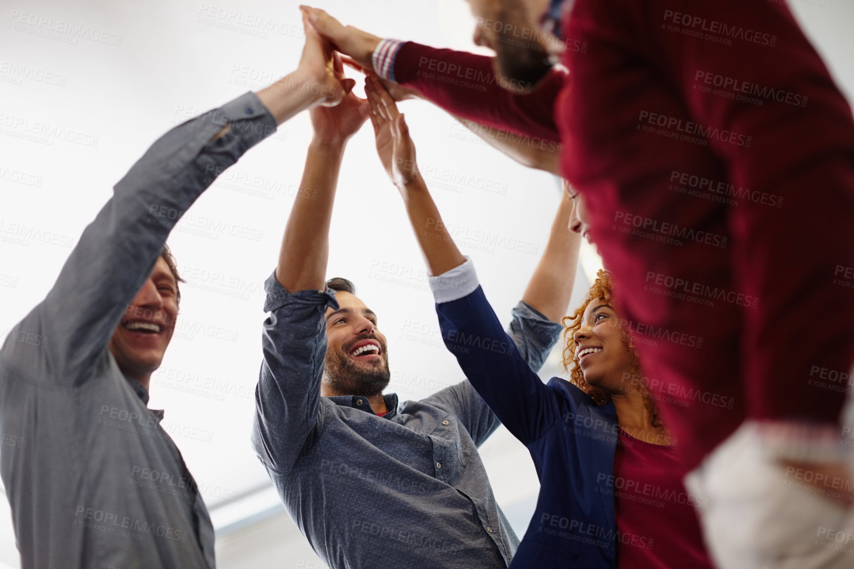 Buy stock photo Shot of a team of businesspeople giving each other a high five in the office