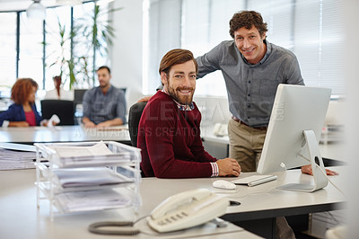 Buy stock photo Portrait of a businessman and his colleague working together on a computer in the office