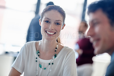 Buy stock photo Portrait of a smiling businesswoman sitting in the office with her colleagues