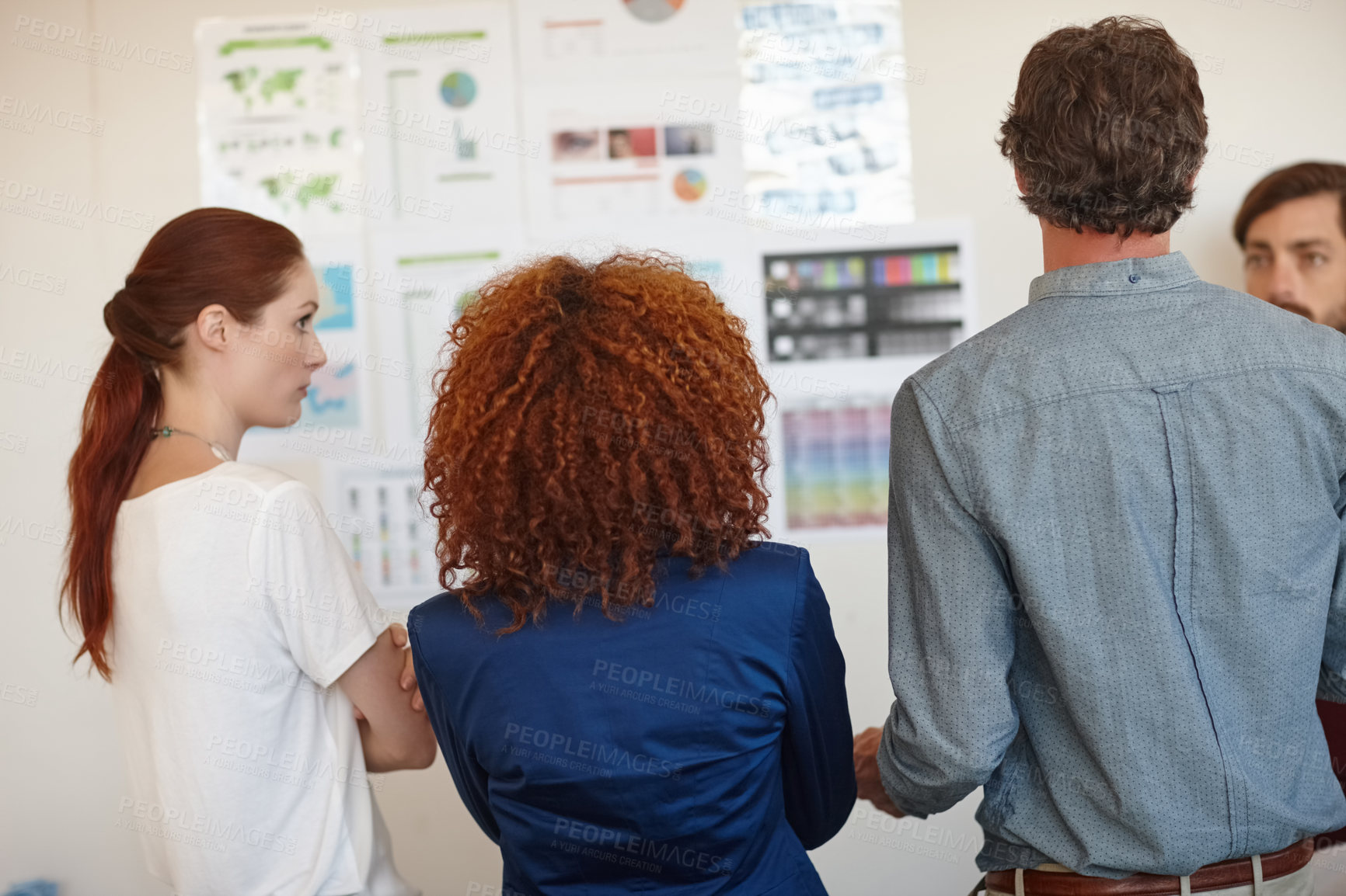 Buy stock photo Shot of a group of businesspeople listening to a colleague's presentation in the office