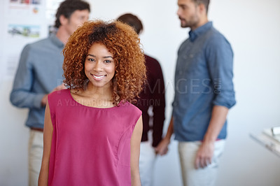 Buy stock photo Portrait of a businesswoman standing in the office with her colleagues in the background