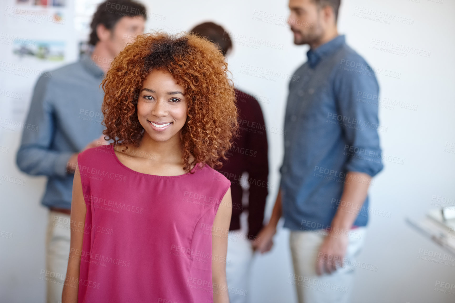 Buy stock photo Portrait of a businesswoman standing in the office with her colleagues in the background