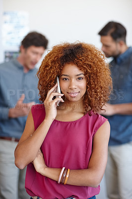 Buy stock photo Portrait of a businesswoman using her cellphone in the office with her colleagues in the background