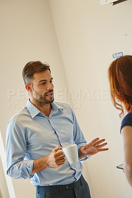Buy stock photo Shot of two colleagues having a discussion at work