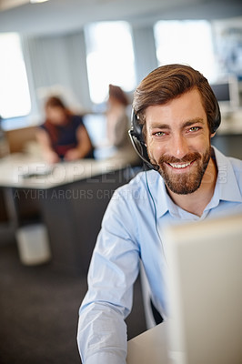 Buy stock photo Portrait of a man working with a headset and computer at his desk