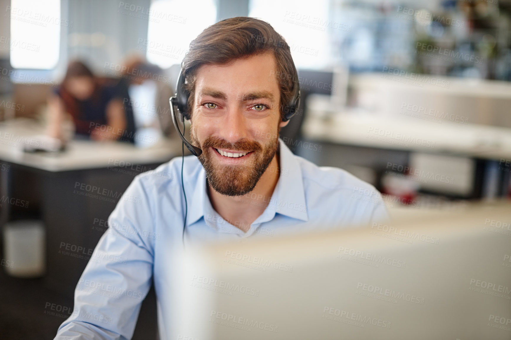 Buy stock photo Portrait of a man working with a headset and computer at his desk