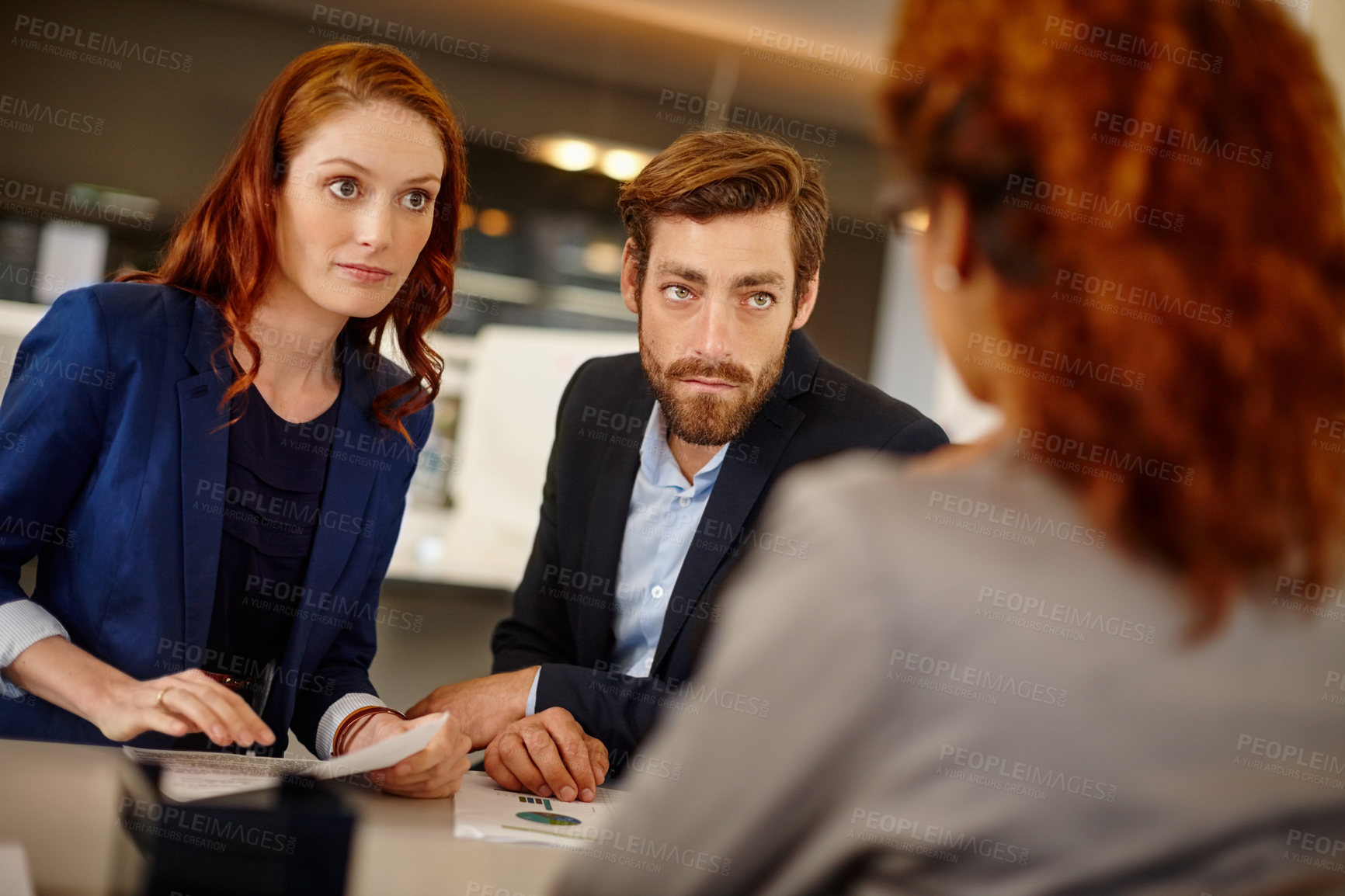 Buy stock photo Shot of colleagues having a face to face meeting with a woman at work