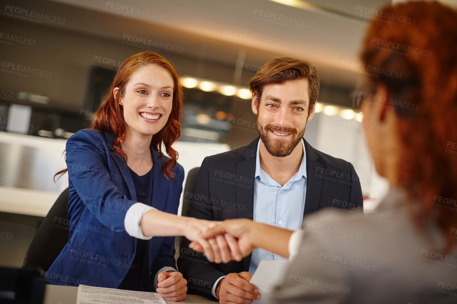 Buy stock photo Shot of two businesswomen shaking hands during a meeting at work