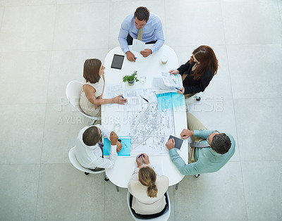 Buy stock photo High angle shot of a group of businesspeople meeting in the office