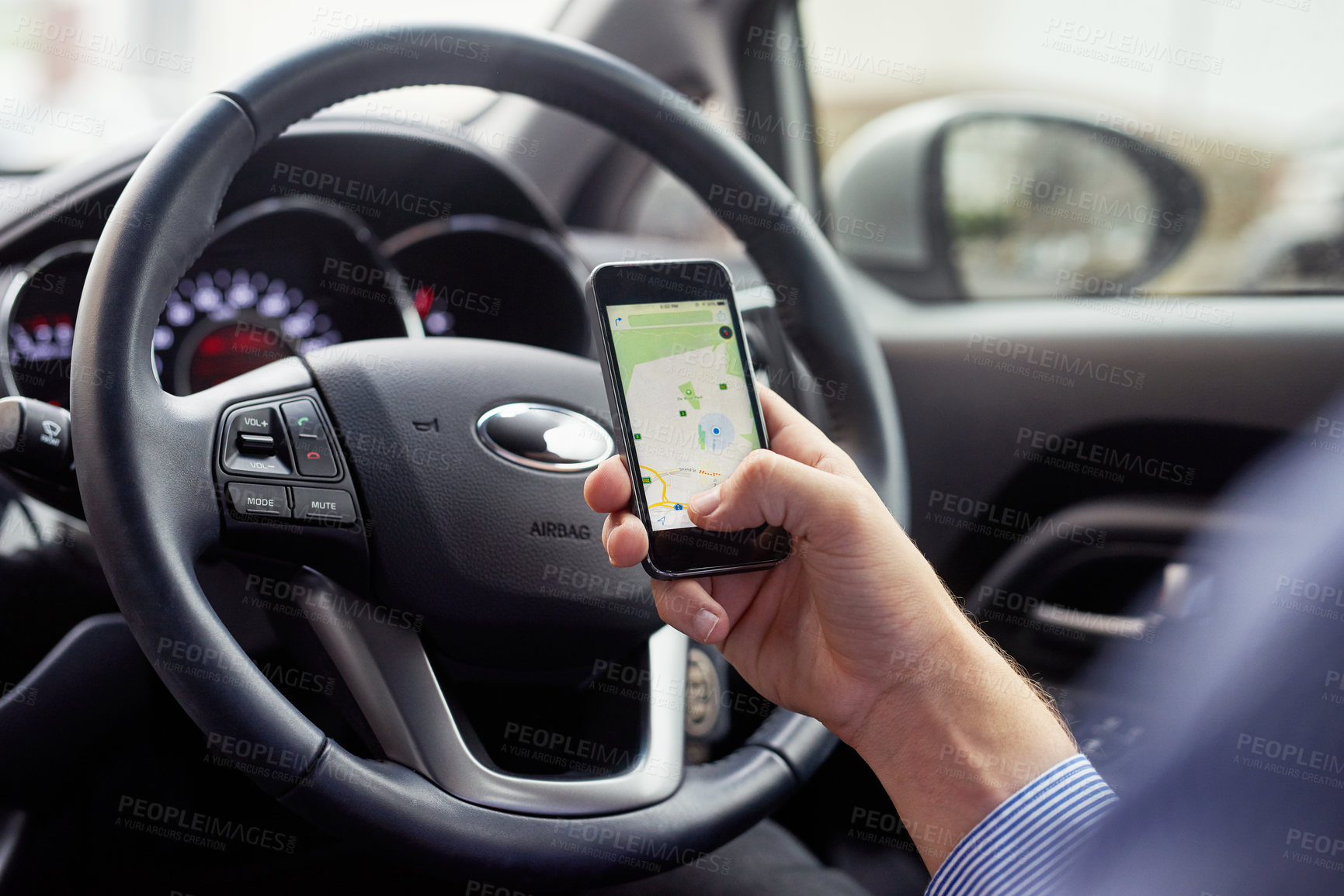 Buy stock photo Closeup shot of a driver in a car using a cellphone to find directions