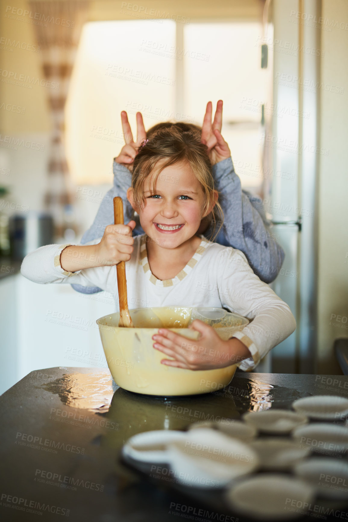 Buy stock photo Cropped shot of two young siblings having fun while baking together at home