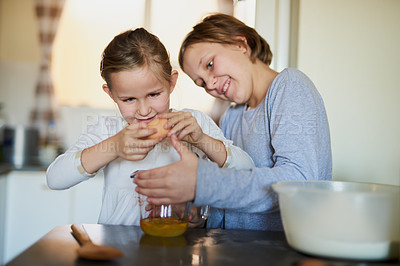 Buy stock photo Cropped shot of two young siblings baking together at home