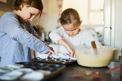 Buy stock photo Cropped shot of two young siblings baking together at home