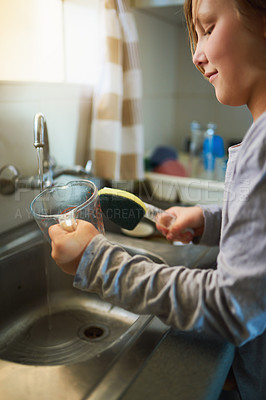 Buy stock photo Cropped shot of a young girl washing dishes at home