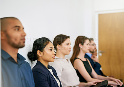 Buy stock photo Shot of a group of businesspeople seated in line while waiting to be interviewed