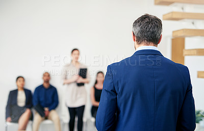 Buy stock photo Shot of an unrecognizable interviewer calling the next candidate to interview