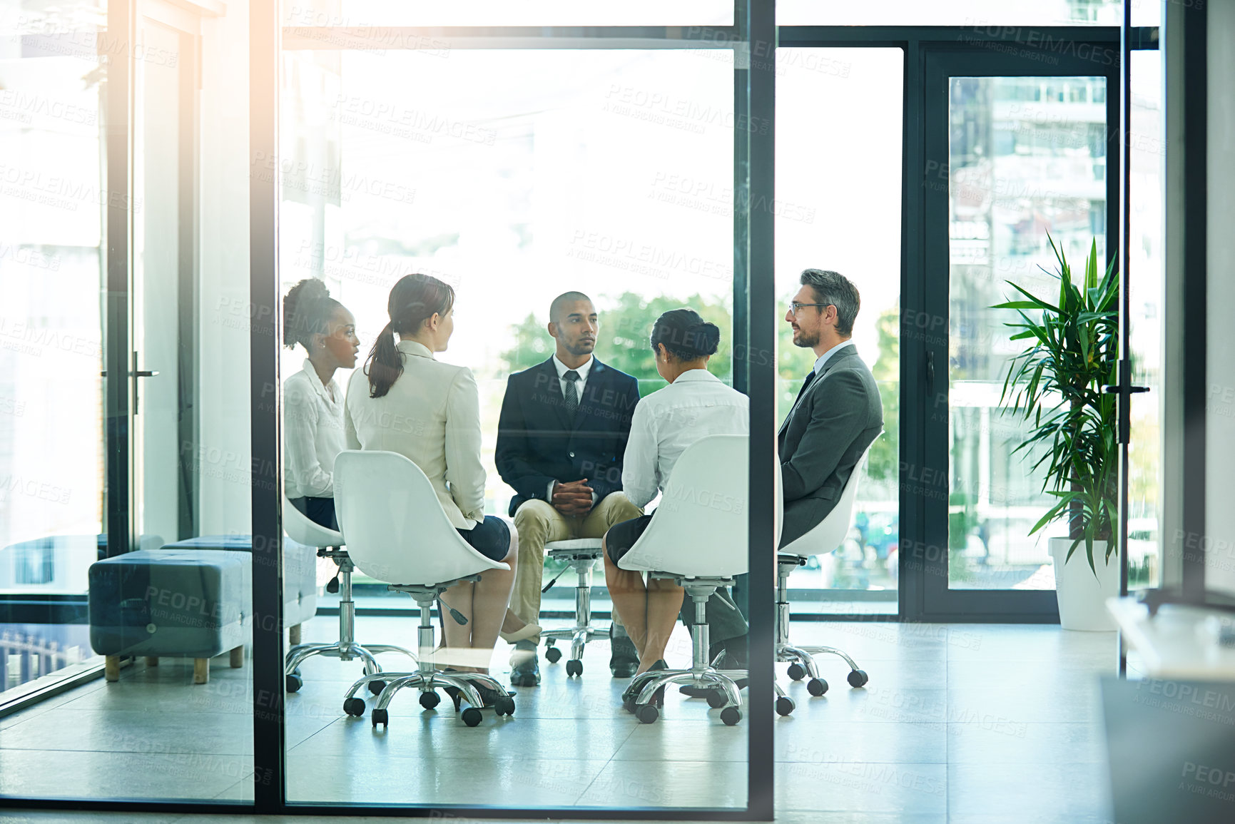 Buy stock photo Shot of a diverse group of businesspeople having a meeting in the boardroom