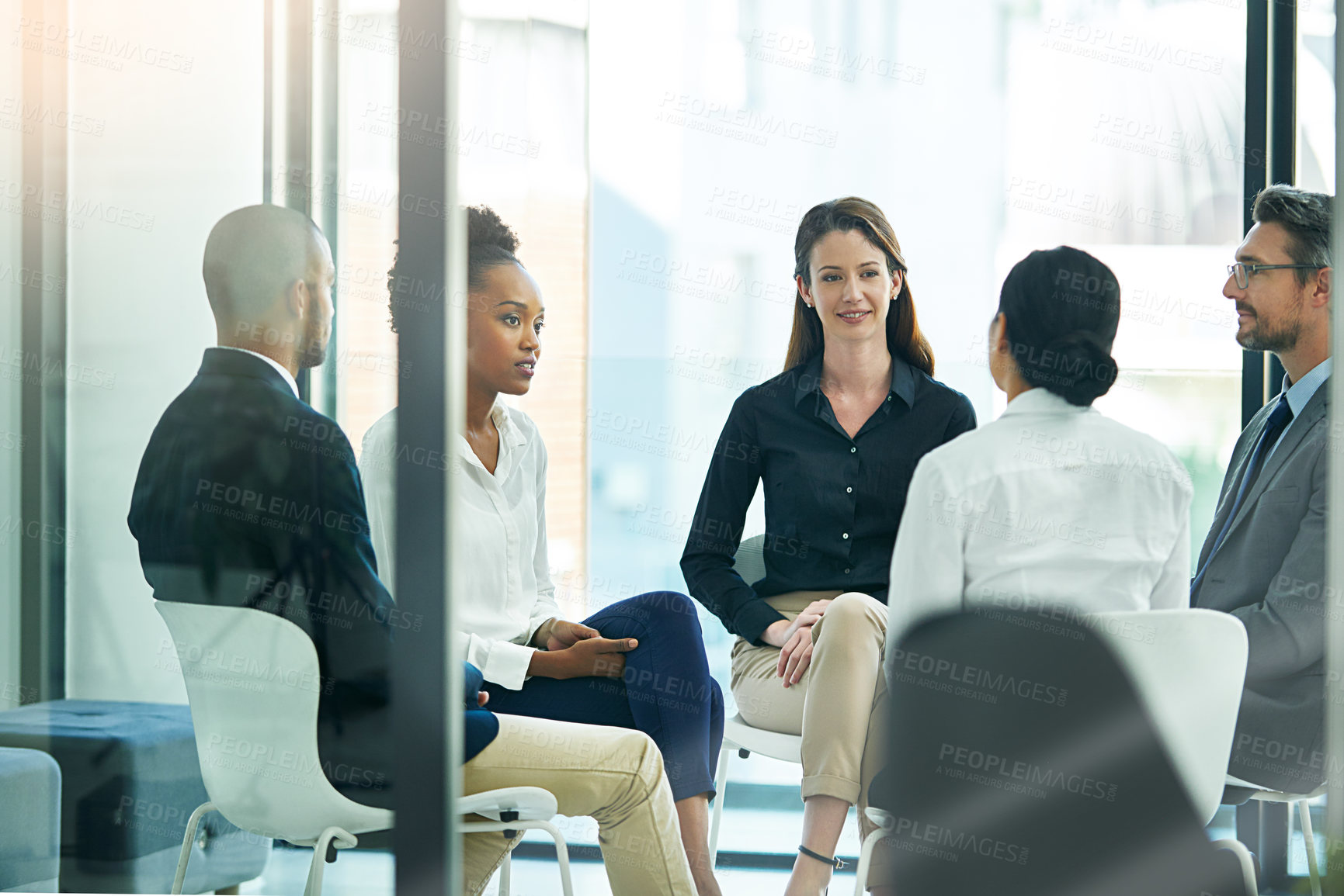 Buy stock photo Shot of a diverse group of businesspeople having a meeting in the boardroom