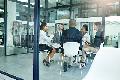 Buy stock photo Shot of a diverse group of businesspeople having a meeting in the boardroom