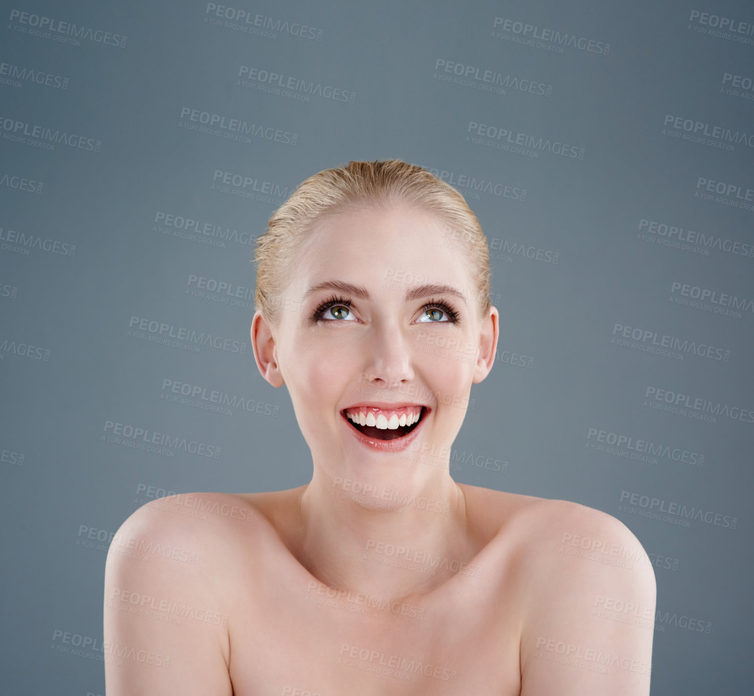 Buy stock photo Studio shot of a young woman with beautiful skin isolated on gray