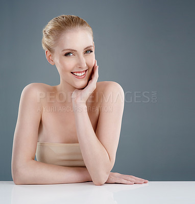 Buy stock photo Studio portrait of a young woman with beautiful skin isolated on gray