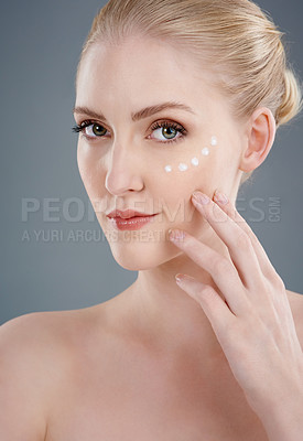 Buy stock photo Studio portrait of a young woman with beautiful skin isolated on gray