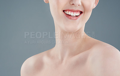 Buy stock photo Studio shot of a younng woman with beautiful skin isolated on gray