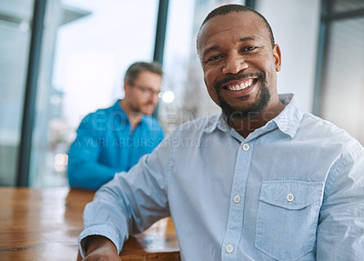 Buy stock photo Portrait of a businessman sitting in the office with a colleague in the background