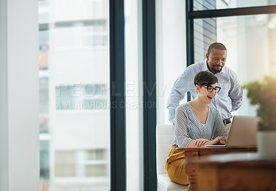 Buy stock photo Cropped shot of two businesspeople working together in the office