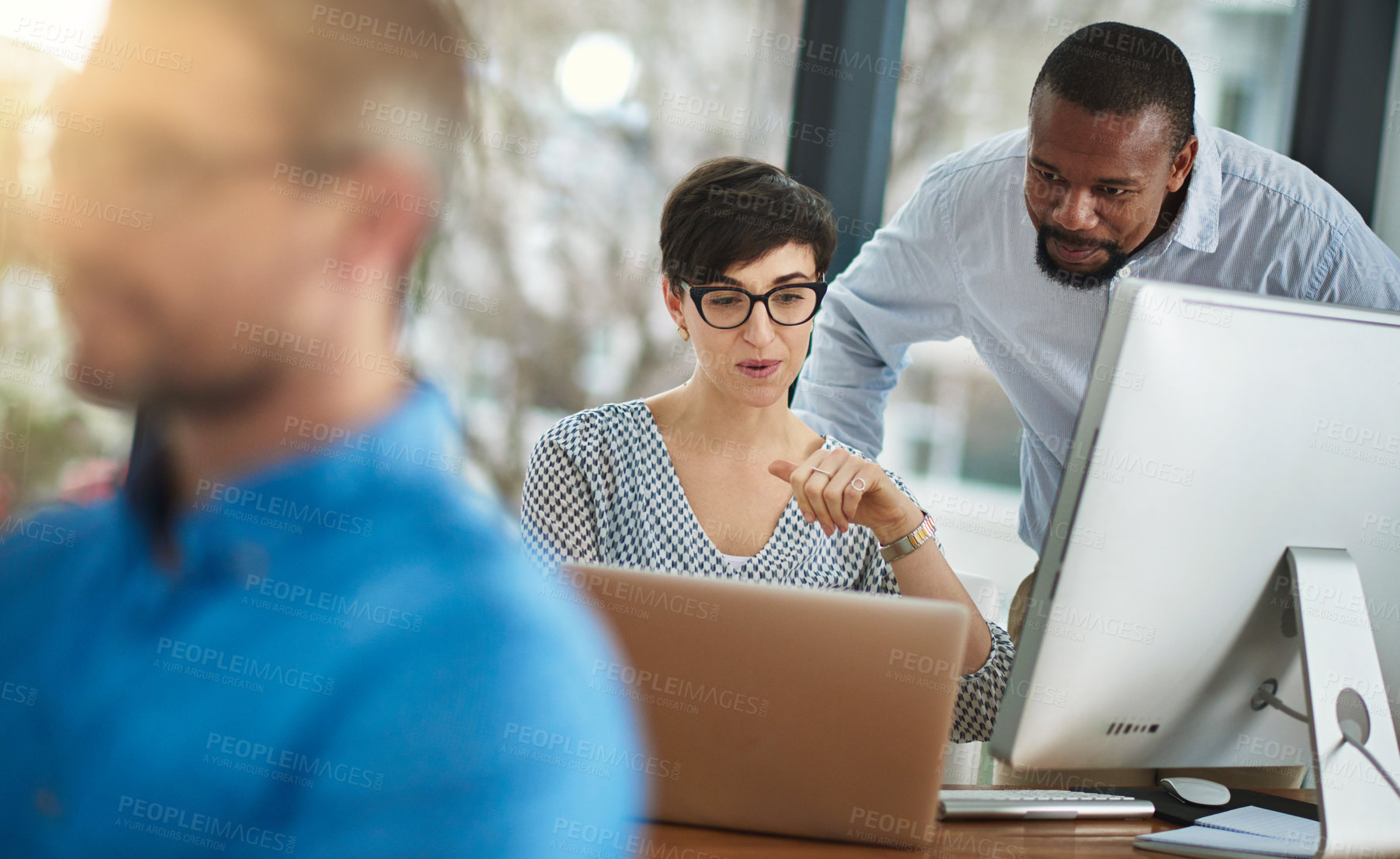 Buy stock photo Cropped shot of two businesspeople working together in the office