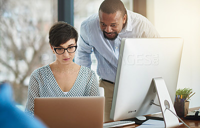Buy stock photo Cropped shot of two businesspeople working together in the office
