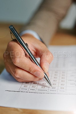 Buy stock photo Closeup shot of a man filling out a medical questionnaire