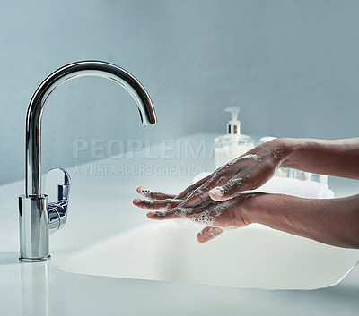 Buy stock photo Cropped shot of a man washing his hands in a bathroom sink
