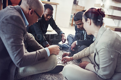 Buy stock photo Cropped shot of a group of coworkers putting a puzzle together