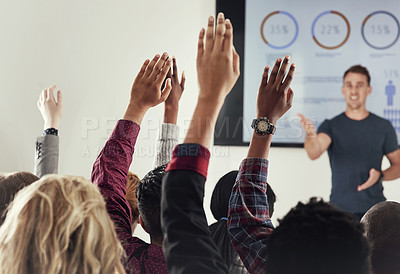 Buy stock photo Cropped shot of a group of people raising their hands in a class