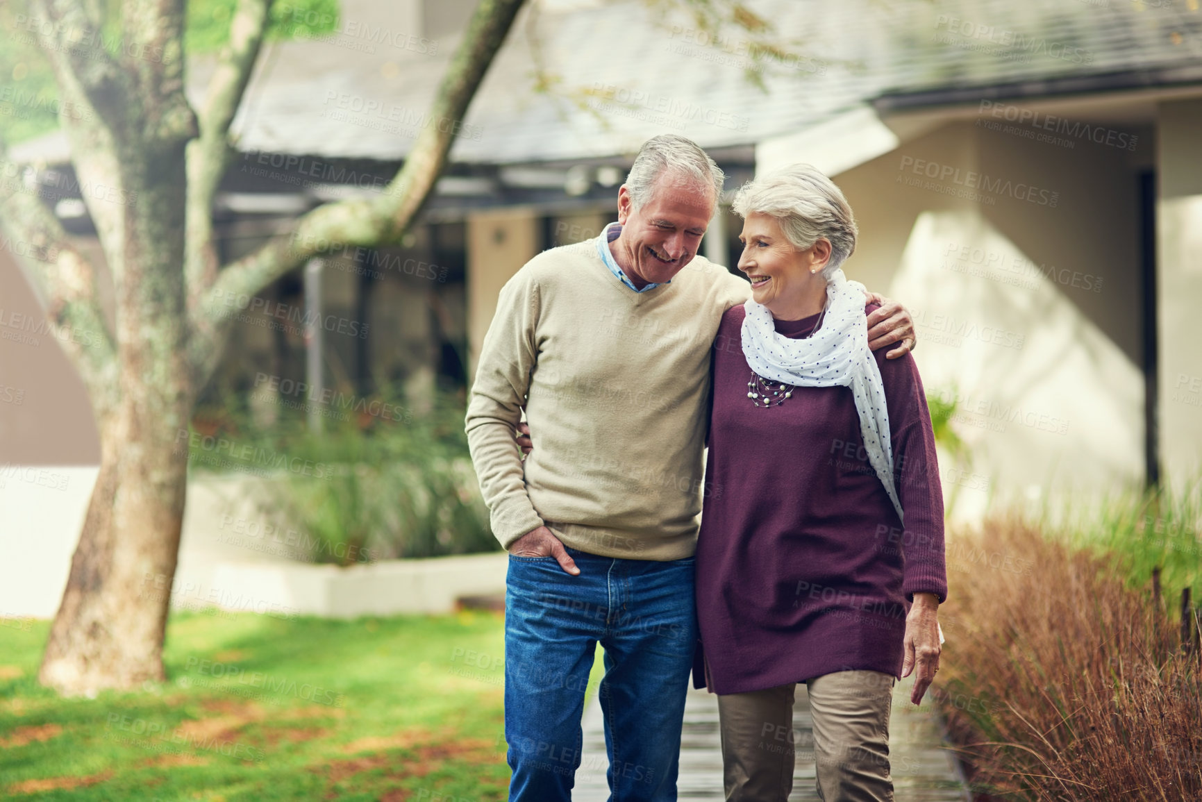 Buy stock photo Shot of a loving senior couple taking a walk outside