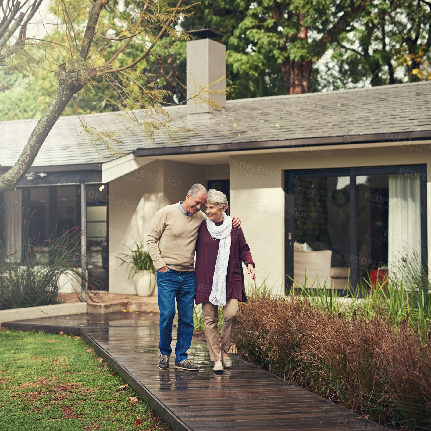 Buy stock photo Shot of a loving senior couple taking a walk outside
