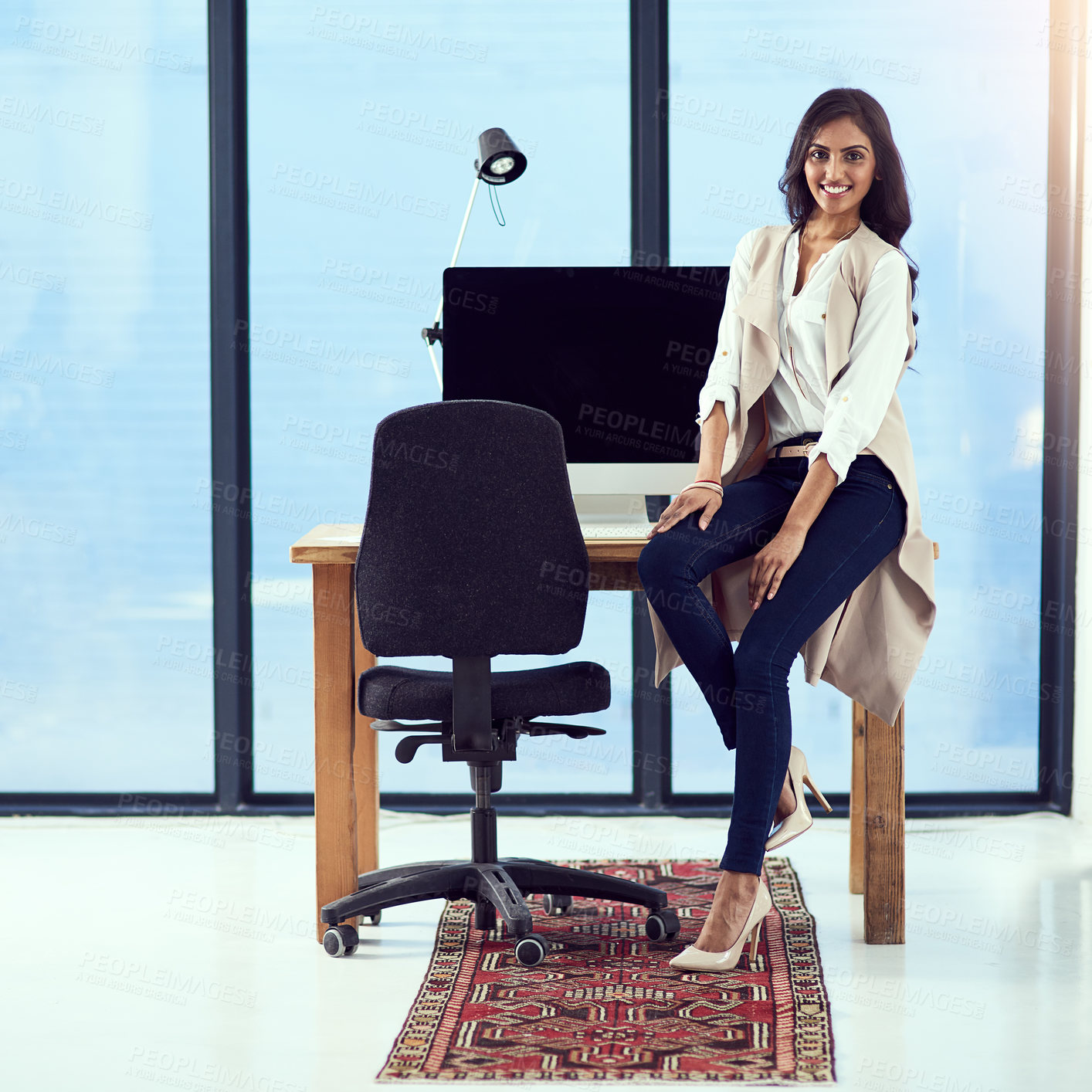 Buy stock photo Portrait of a young designer sitting on her work station desk in front of a window