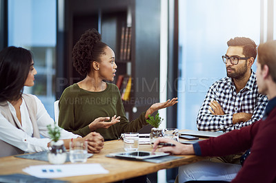 Buy stock photo Shot of a group of businesspeople having a meeting in the boardroom