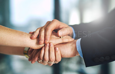 Buy stock photo Cropped shot of two colleagues holding hands