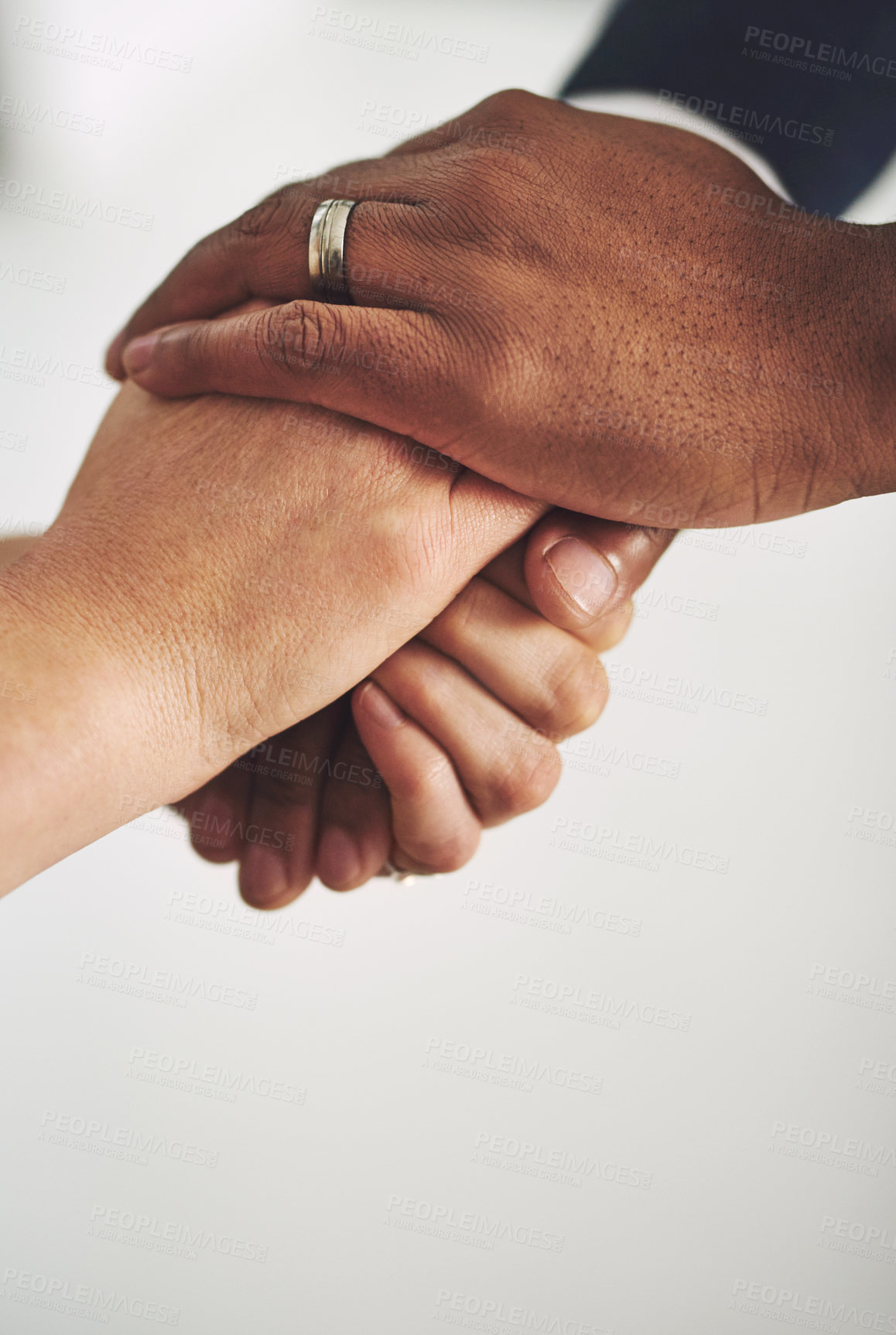 Buy stock photo Cropped shot of two colleagues holding hands